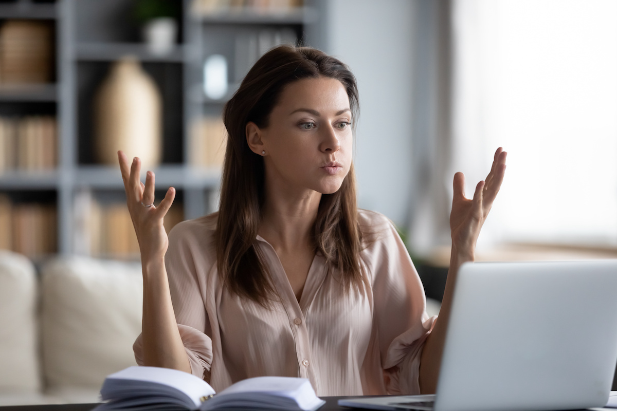 Frustrated woman working on her laptop